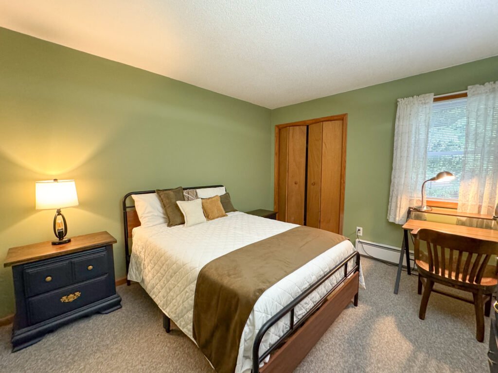 Tranquil bedroom space with full bed, nightstands, and writing desk at the Quiet Pond Lookout vacation rental