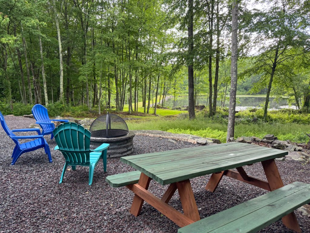 Fire pit and lake view at the Quiet Pond Lookout vacation rental.