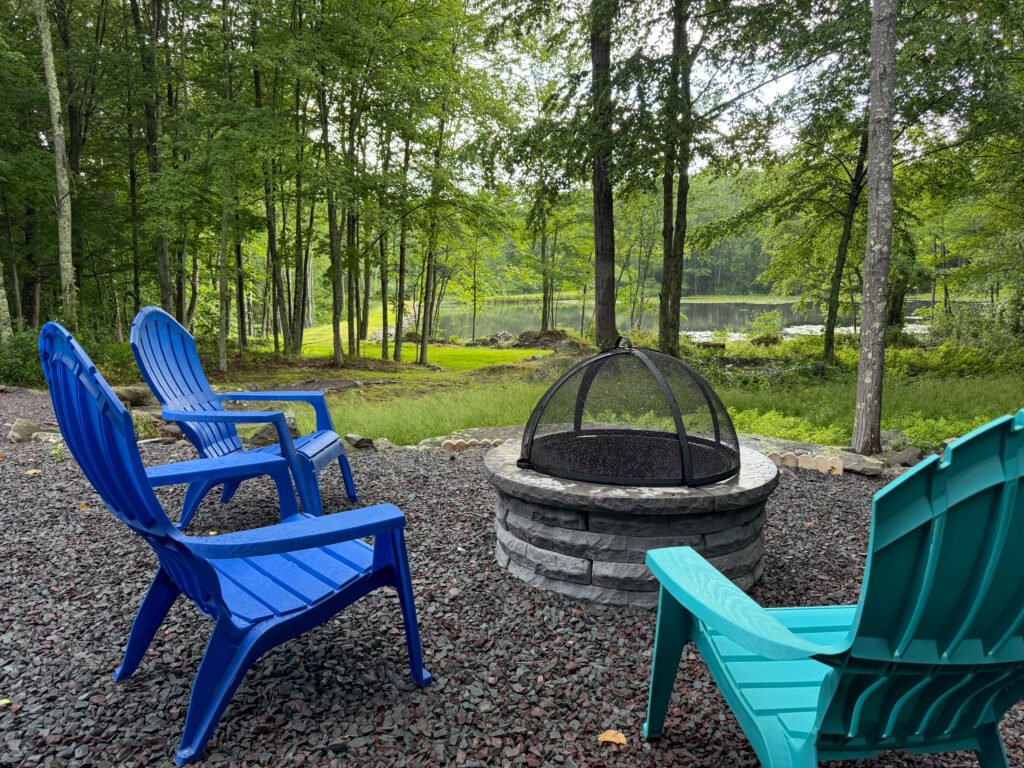 Fire pit and lake view at the Quiet Pond Lookout vacation rental.