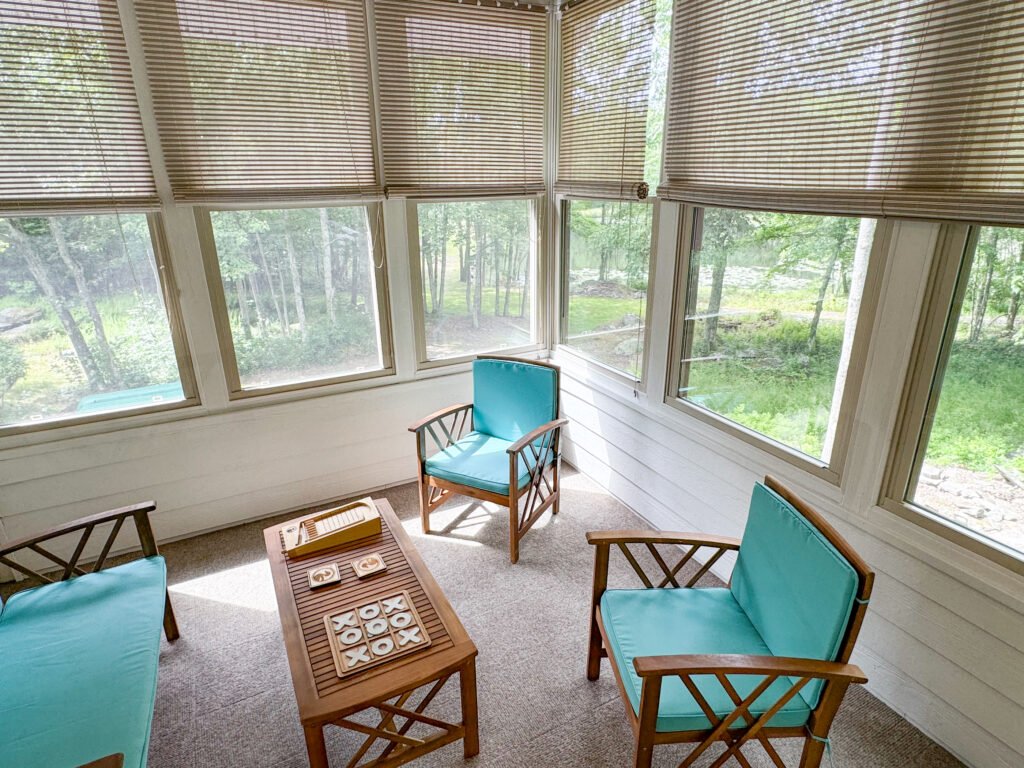 The fully enclosed all-seasons room at the Quiet Pond Lookout, overlooking a 1 acre lake.